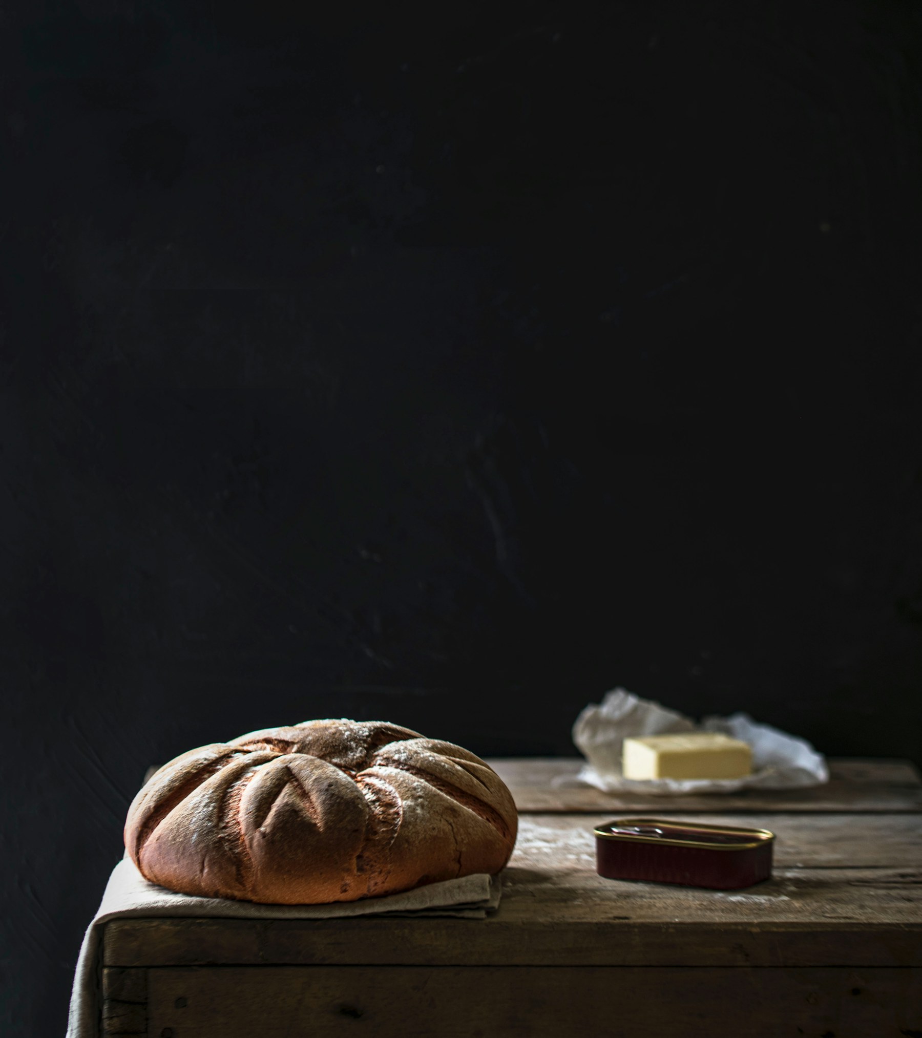Freshly baked artisan bread on a linen-covered table